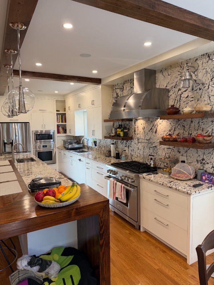 Spacious Northwest Washington, D.C. kitchen renovation with custom cabinets and exposed wood beams.