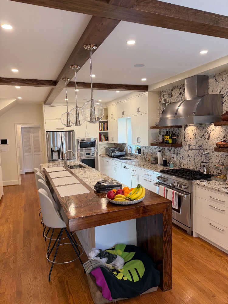 Wide view of a custom kitchen remodel in Northwest Washington, D.C., featuring a waterfall stone island.