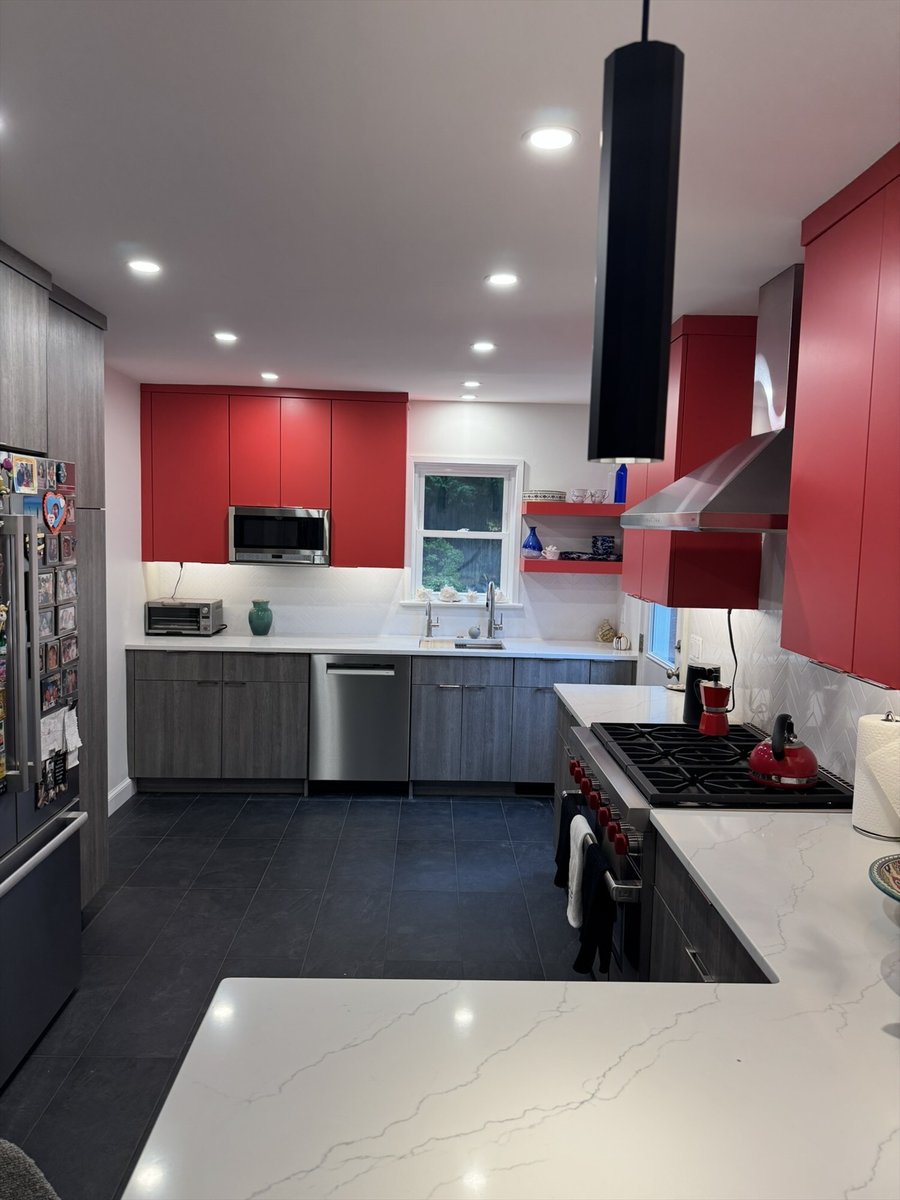 Contemporary kitchen remodel with a gas cooktop, red upper cabinets, and a window over the sink in Chevy Chase, MD - optimized