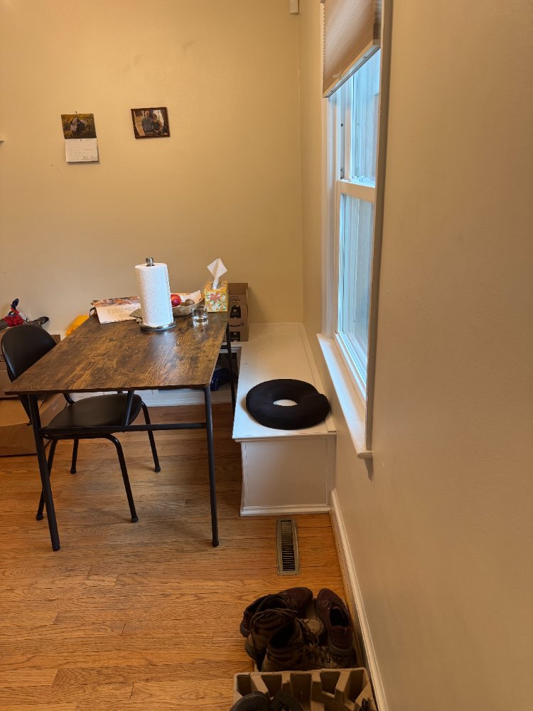 Dining nook with hardwood floors and window bench before renovation in Chevy Chase, MD.