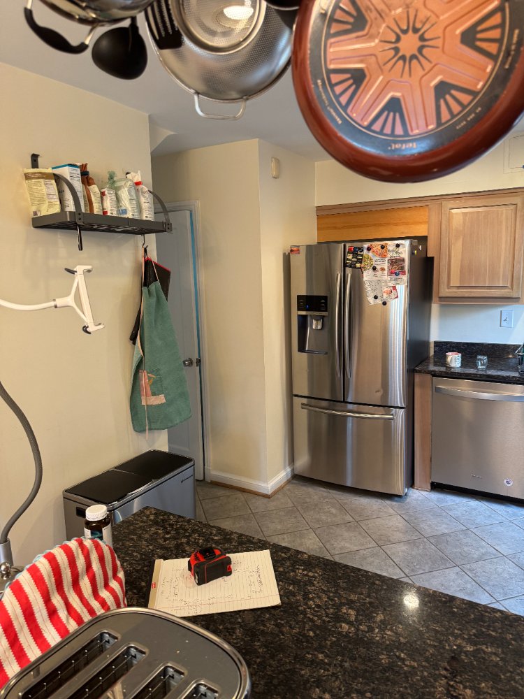 Existing kitchen entry and refrigerator wall before remodeling in Chevy Chase, MD.