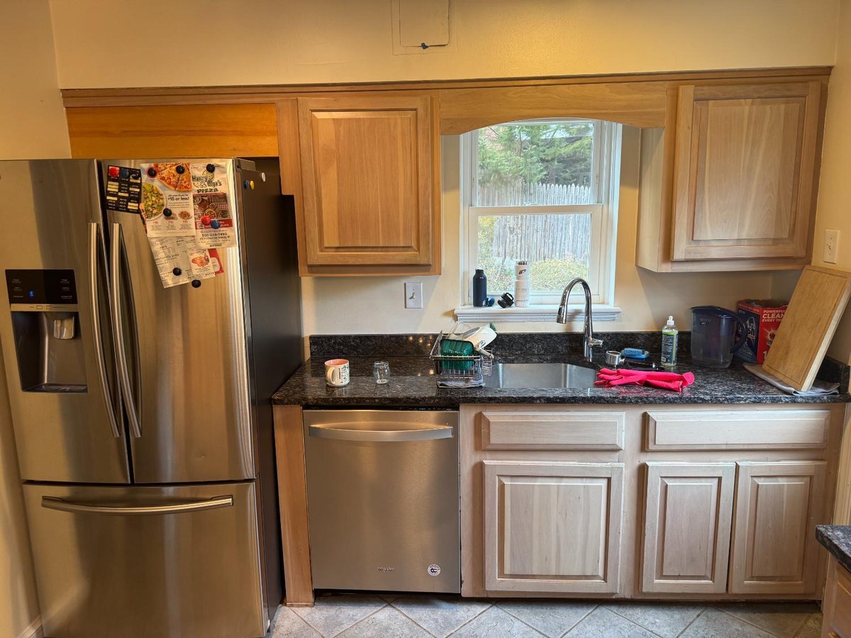 Existing kitchen sink, dishwasher, and cabinetry before remodeling in Chevy Chase, MD.