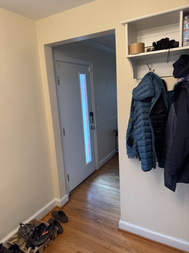 Hallway and entry area connected to the kitchen before renovation in Chevy Chase, MD.