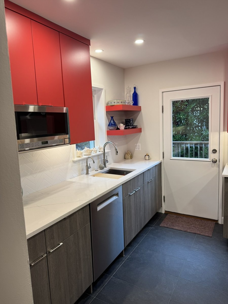 Remodeled galley kitchen with red cabinetry, red floating shelves, and a glass-panel back door in Chevy Chase, MD - optimized