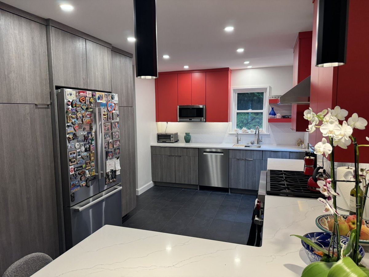 Remodeled kitchen with red upper cabinets, a sink wall with window, and stainless steel appliances in Chevy Chase, MD - optimize