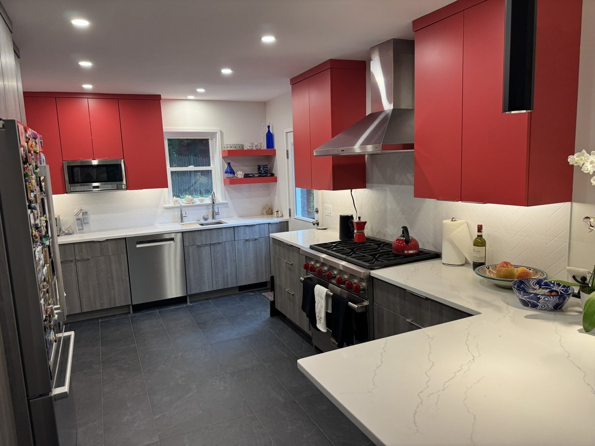 Wide view of the remodeled kitchen with red upper cabinets, gray lower cabinets, and quartz countertops in Chevy Chase, MD - opt