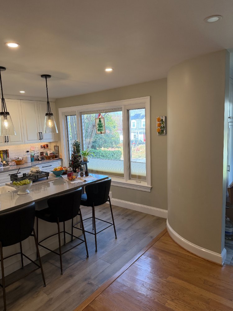 Bethesda, MD kitchen remodel featuring a large farmhouse sink, quartz island, and pendant lighting.