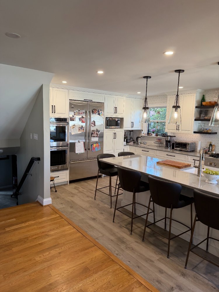 Kitchen remodel in Bethesda, MD with custom cabinetry, built-in appliances, and a large island.