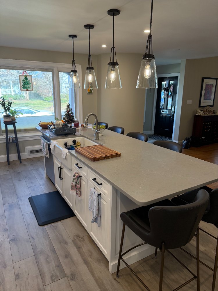 Kitchen remodel featuring a farmhouse sink, quartz island, and large windows in Bethesda, MD.