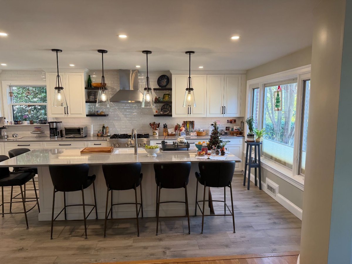 Open-concept kitchen renovation in Bethesda, MD with a large island, stainless steel range hood, and custom cabinetry.
