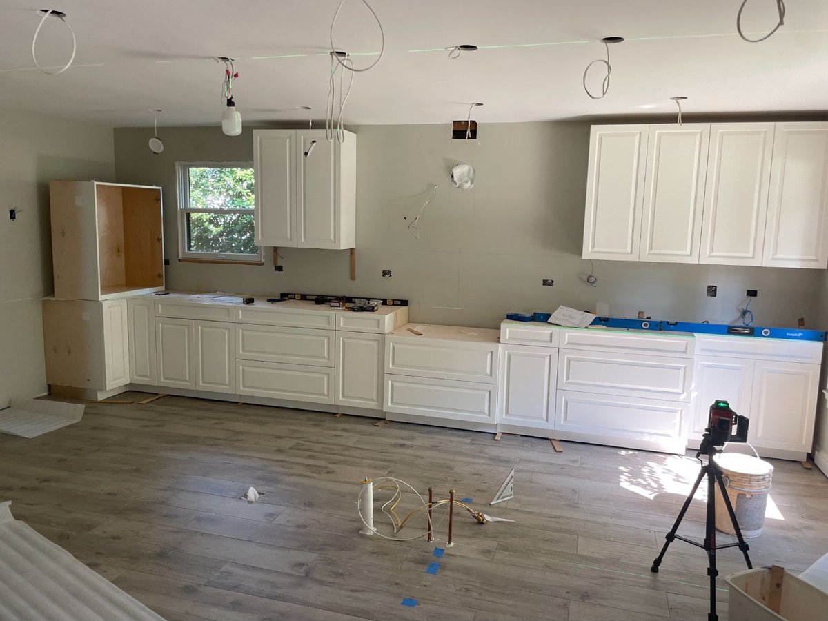 White shaker cabinets being installed during a kitchen remodel in Bethesda, MD.