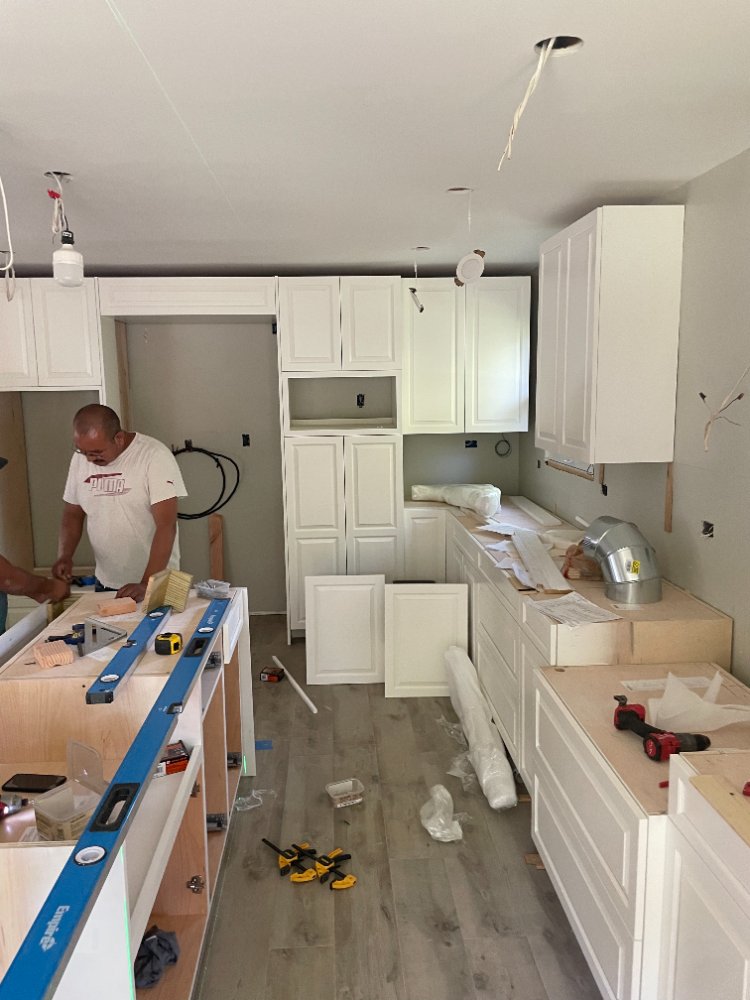 Wide view of white shaker cabinet installation during a Bethesda, MD kitchen remodel.