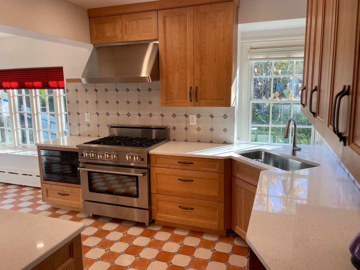 Chevy Chase, MD kitchen remodel featuring custom cabinets, quartz counters, and a large picture window.