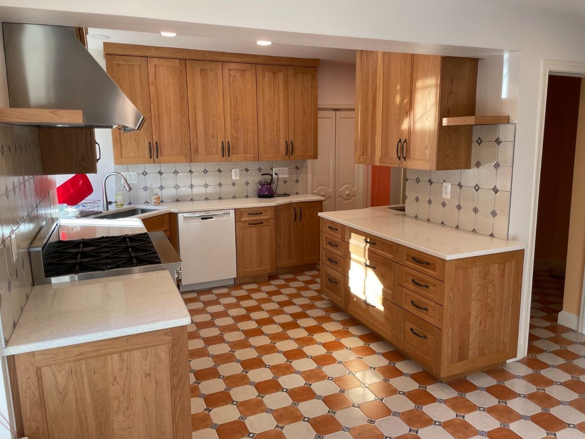 Chevy Chase, MD kitchen remodel with custom refrigerator enclosure and floor-to-ceiling cabinetry.