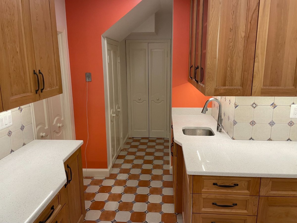 Custom kitchen remodel highlighting quartz countertops, wood cabinetry, and a prep sink in Chevy Chase, MD.