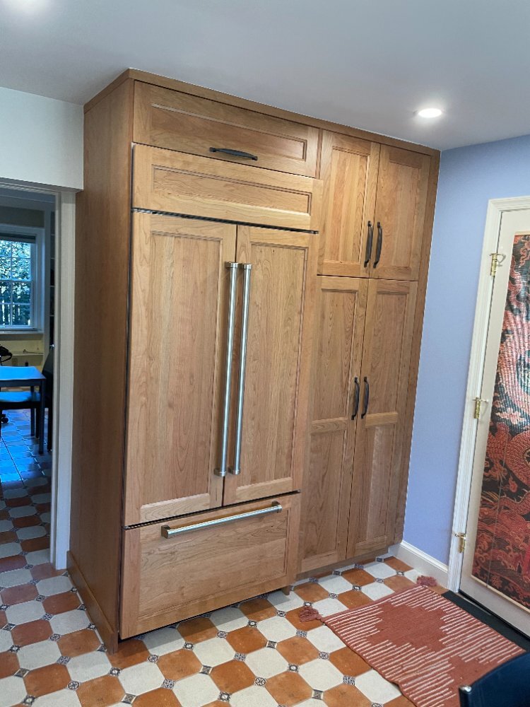 Finished Chevy Chase, MD kitchen renovation with custom cabinetry, quartz countertops, and decorative tile flooring.