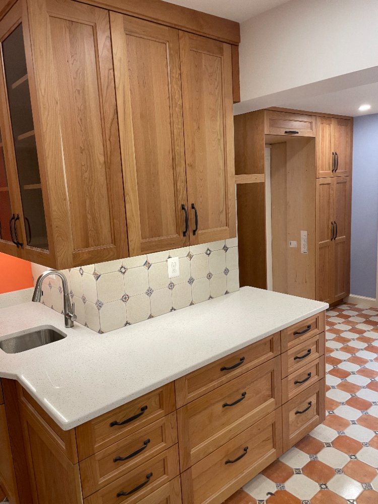 Kitchen island with custom wood cabinetry and quartz countertop in Chevy Chase, MD.