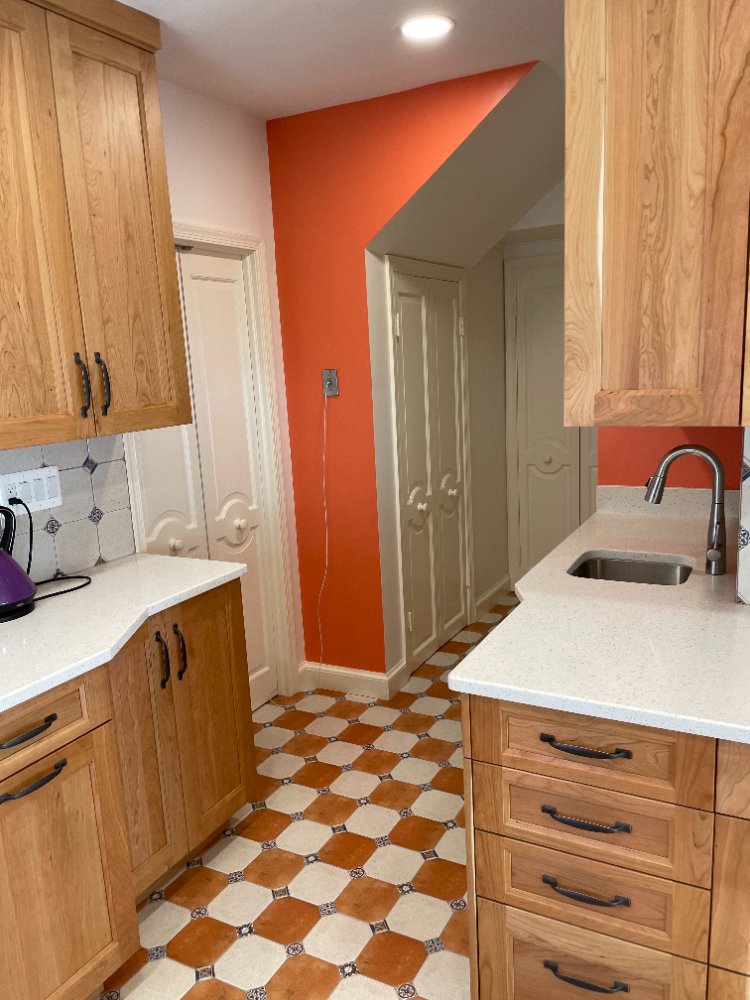 Kitchen remodel showcasing custom cabinetry, quartz countertops, and a spacious center island in Chevy Chase, MD.