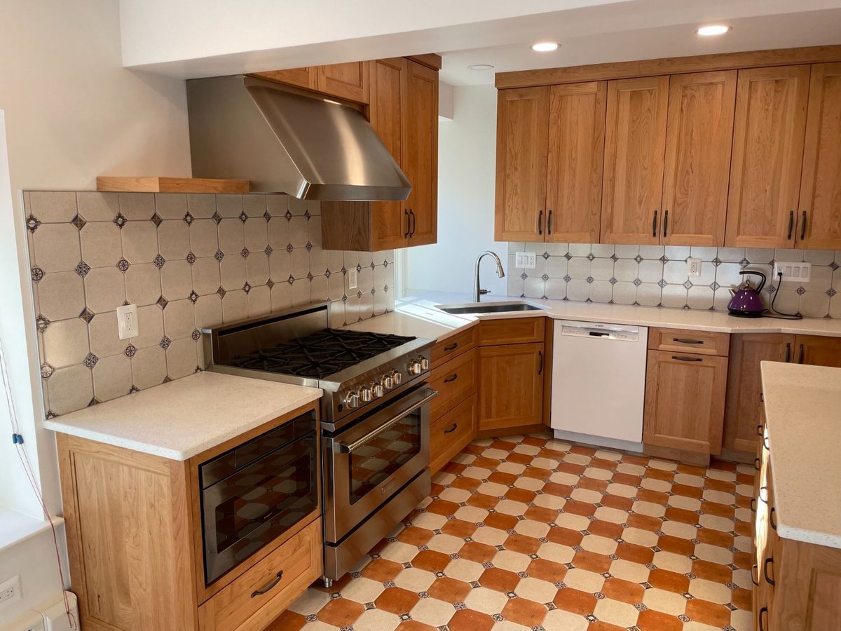 Luxury kitchen remodel with custom cabinetry, quartz countertops, and a stainless steel range in Chevy Chase, MD.