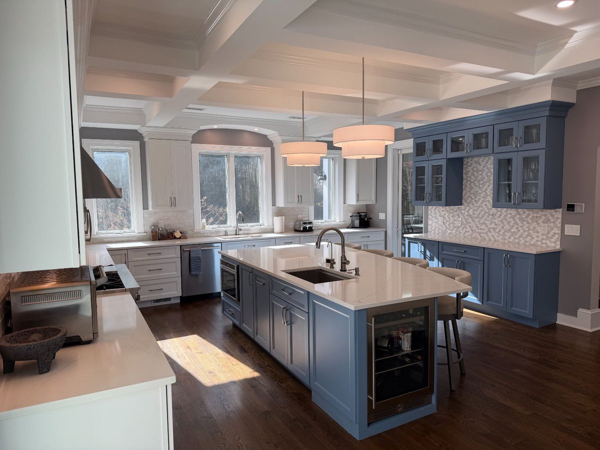 Custom remodeled kitchen with a blue island, built-in microwave drawer, and quartz countertops in Chevy Chase, MD.