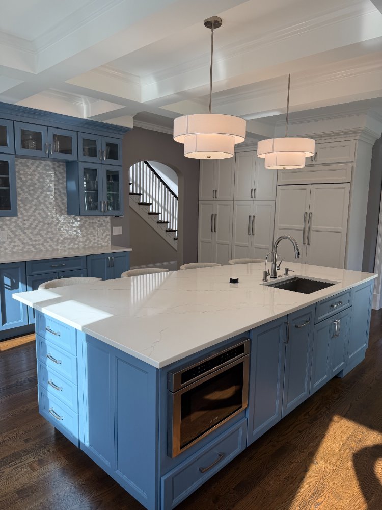 Luxury kitchen remodel featuring a blue island and custom white cabinetry in Chevy Chase, MD.