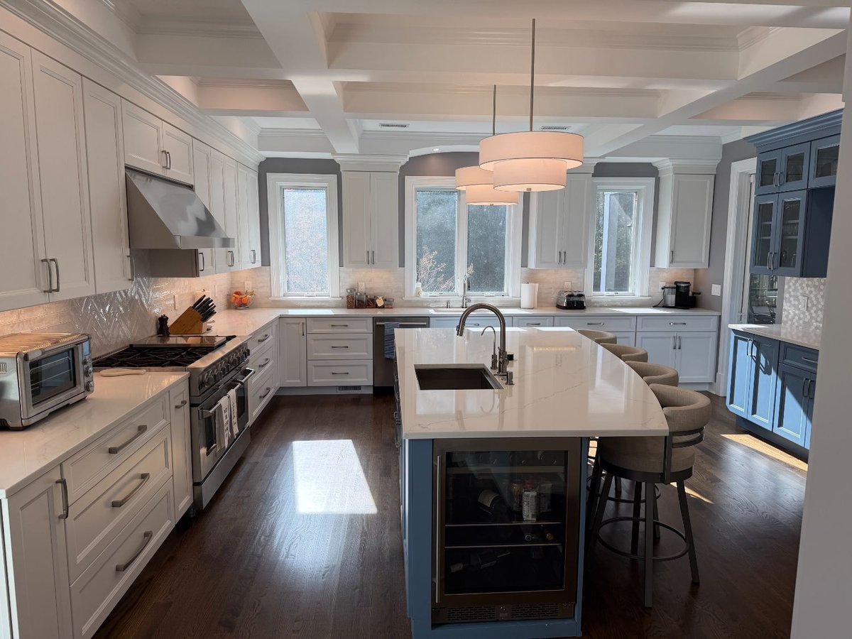 Luxury remodeled kitchen with a blue island, coffered ceiling, and custom cabinetry in Chevy Chase, MD.