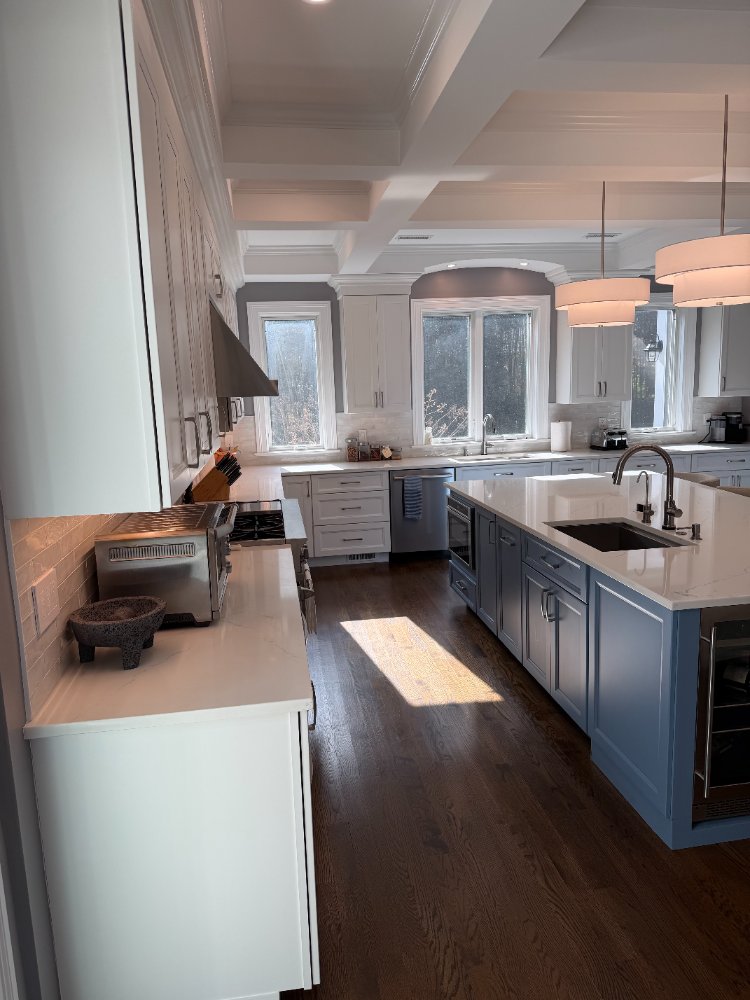 Remodeled kitchen with a custom blue hutch, quartz island, and coffered ceiling in Chevy Chase, MD.