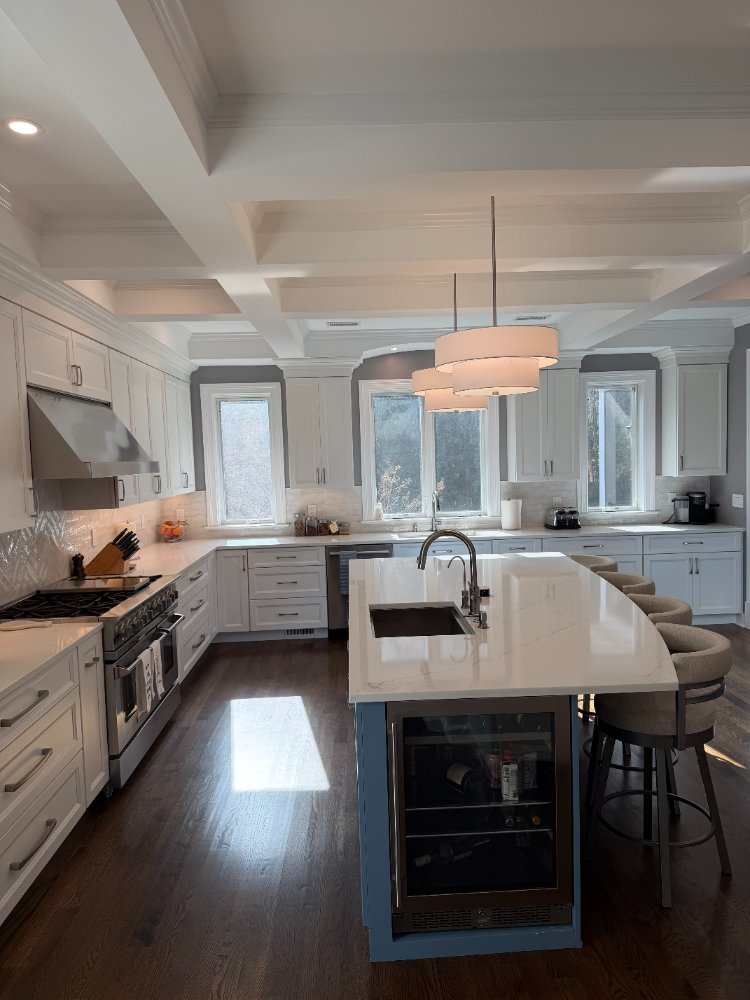 Spacious remodeled kitchen with a blue island, custom cabinetry, and stainless steel appliances in Chevy Chase, MD.