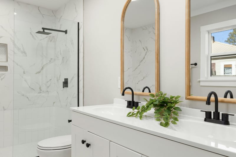 Bright bathroom with custom vanity, marble tile, and matte black fixtures completed by Managed Renovations in Chevy Chase, MD st-optimized