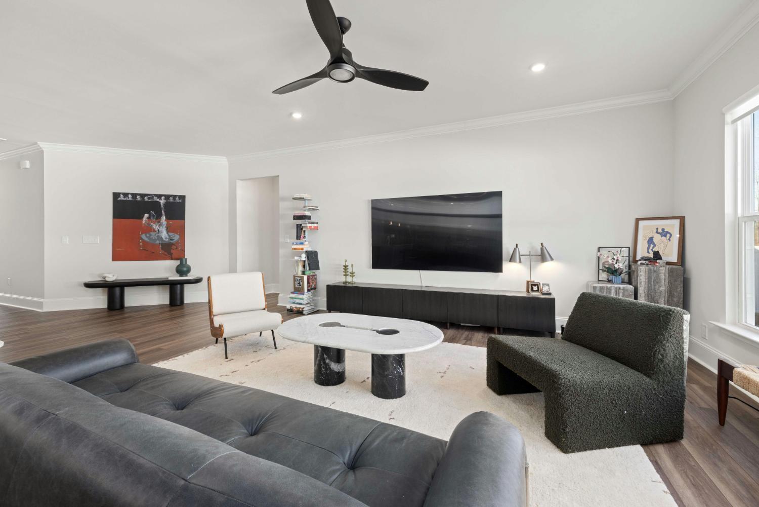 Contemporary living room with minimalist furnishings in a whole home remodeling project by Managed Renovations in Chevy Chase, M-optimized