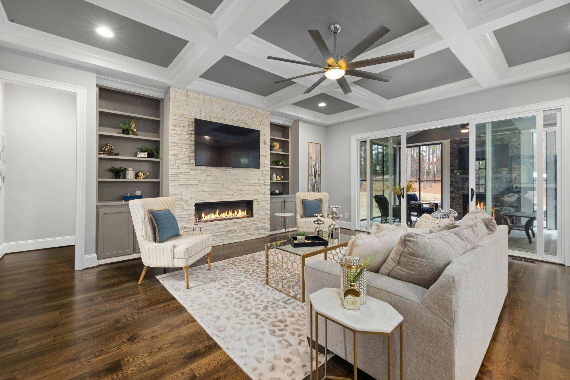 Luxury living room with stone fireplace and coffered ceiling in a whole home remodeling project by Managed Renovations in Chevy Chase -optimized