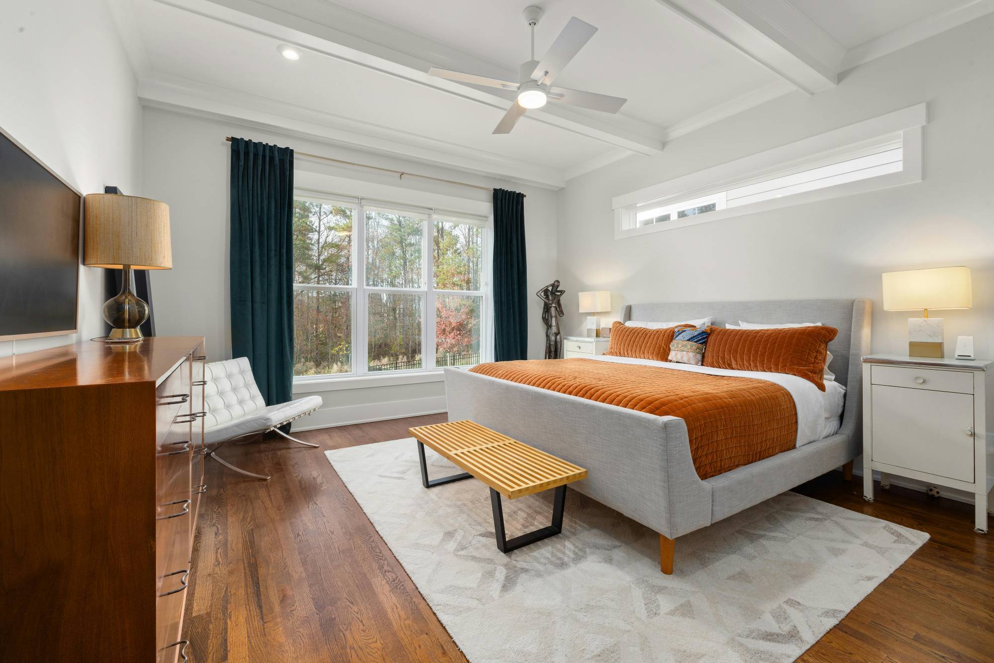 Modern primary bedroom with upholstered bed in a whole home remodeling project by Managed Renovations in Chevy Chase, MD stock-optimized