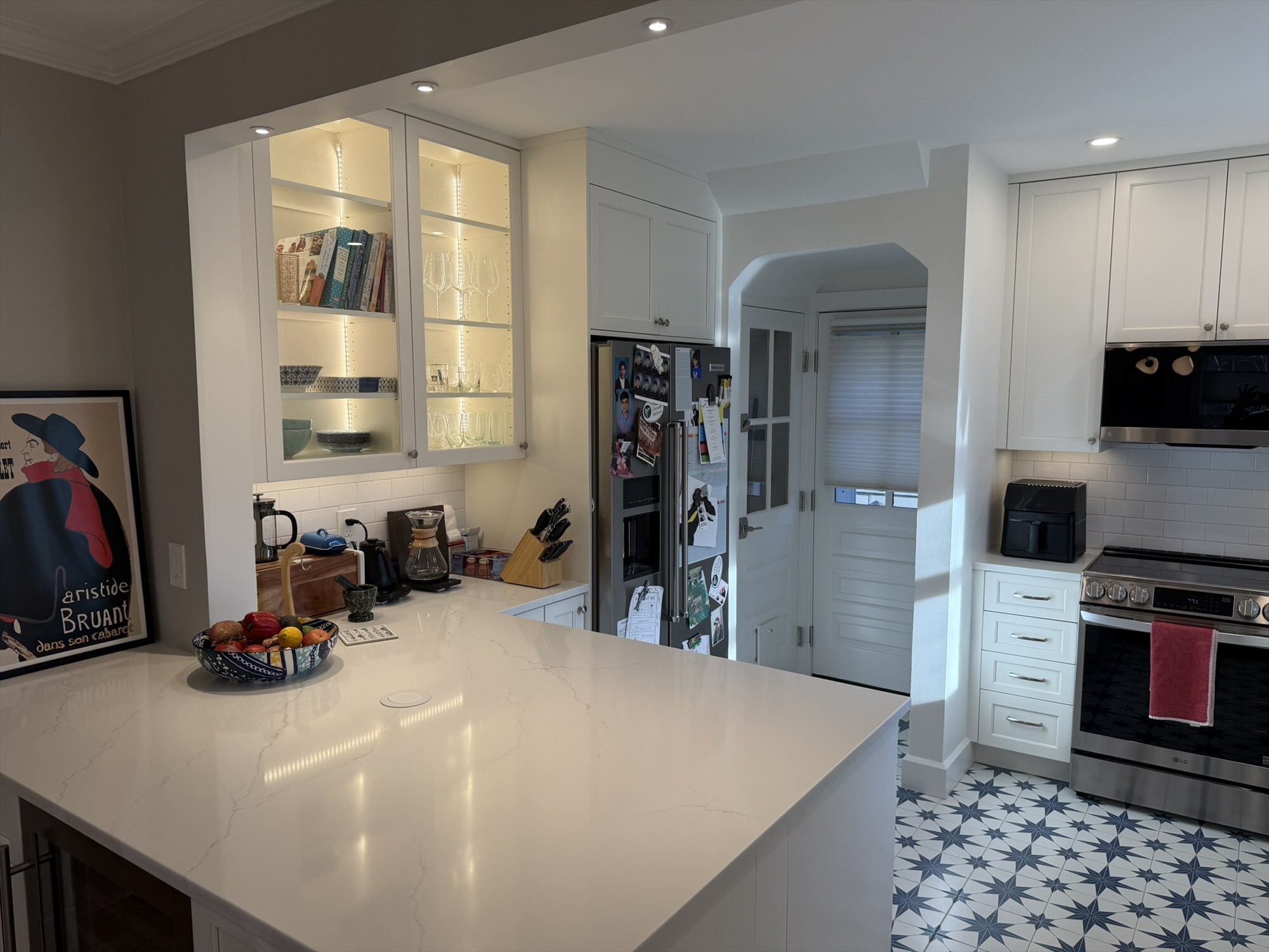 glass front cabinet display with stainless refrigerator and star pattern tile floor kitchen renovation - optimized