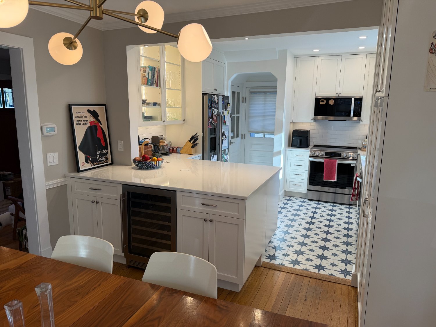 Bloom Kitchen Remodel by Managed Renovations in Chevy Chase, MD featuring a white quartz island, custom cabinetry, and patterned-optimized