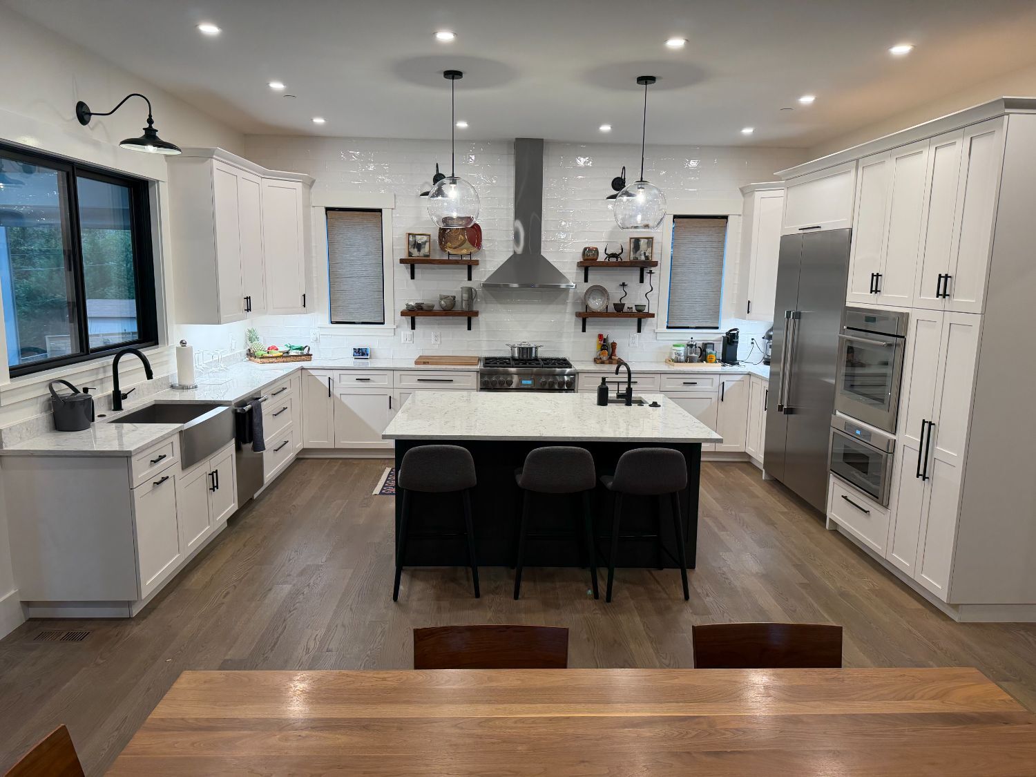 Front-facing view of the Wurster new house custom kitchen by Managed Renovations in Chevy Chase, MD featuring a spacious island -optimized