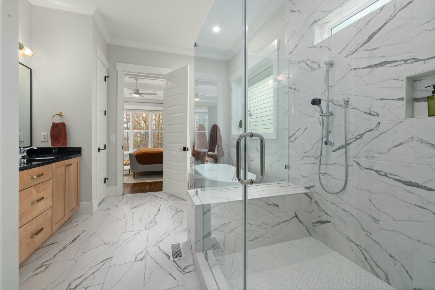 Luxury bathroom featuring a glass walk-in shower and custom wood vanity by Managed Renovations in Chevy Chase, MD stock-optimized